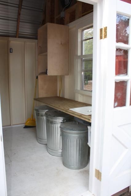 Love the inside set up of this coop. Lots of storage! Barn style chicken coop. Chicken Coop Organization, Feed Shed Organization, Animal Feed Storage Ideas, Chicken Coop Organization Ideas, Small Feed Room Ideas, Feed Room Organization, Feed Room, Small Tack Room Organization, Feed Room Ideas Barn