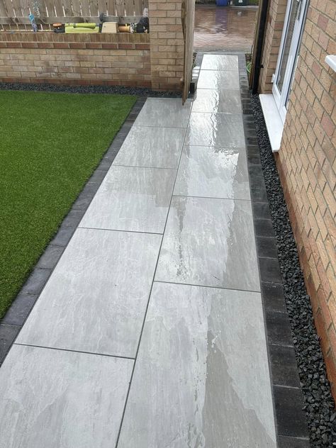 A beautifully modern patio whilst using a more traditional look paving. Aged Kandla Grey porcelain gives you the look of natural stone, but with porcelain low maintenance. 📞Call our team on 01977 782240 💻Visit the product on our website https://rflandscapeproducts.co.uk/product/aged-kandla-grey-2cm-porcelain-paving/ Details ✔️ Product : Aged Kandla Grey Porcelain Format - 600x900x2cm Material - Porcelain Available in drainage, copings and bullnosed steps. ✔️Trade accounts available ... Grey Patio Paving, Grey Porcelain Patio, Porcelain Patio, Grey Paving, Porcelain Paving, Grey Patio, Traditional Look, Bungalow Design, Patio Designs