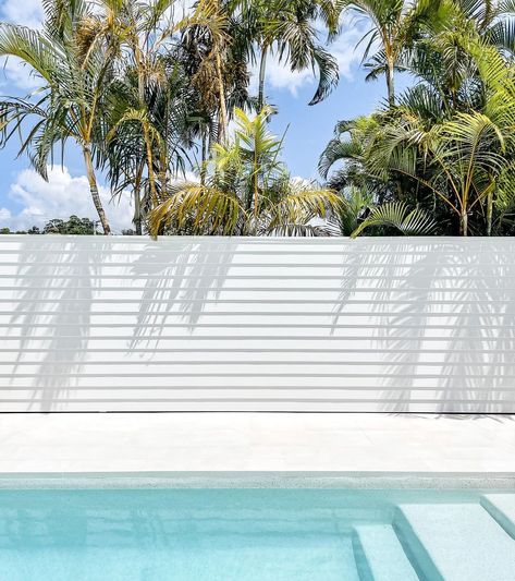 Dilly Shack on Instagram: “Here it is, in all its glory! Our feature wall by the pool, finally painted and creating the perfect backdrop for shadow play on a sunny…” Pool White Fence, Pool Fence Screening Ideas, Pool Cladding Ideas, Pool Screening Ideas, Swimming Pool Feature Wall, Pool Walls Ideas, Pool Screen Privacy Ideas, White Pool Area, White Pool Fence