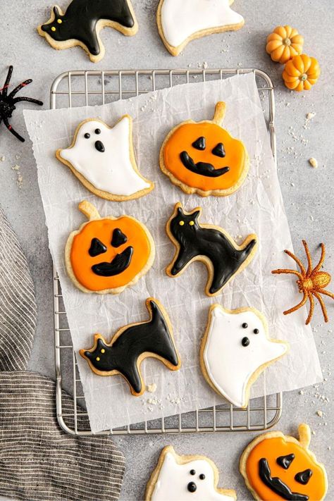 Halloween sugar cookies decorated with royal icing: orange Jack-o'-lanterns with black facial features, black cats with glowing yellow eyes, and white ghosts with black details. Halloween Icing, Black Cat Cookies, Sugar Cookies From Scratch, Halloween Sugar Cookies Decorated, Sugar Cookies With Royal Icing, Cookies With Royal Icing, Halloween Cookies Decorated, Halloween Sugar Cookies, Ghost Cookies