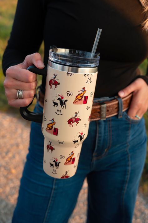 This 40-ounce behemoth holds enough liquid to quench the toughest of thirsts, all while keeping your cool with its stainless steel interior. Plus, it comes with a reusable plastic straw and a leak-proof, screw-on lid for the ultimate protection against accidental spillage. 40 ounces Includes reusable plastic straw All-day chill or heat Stainless steel interior Dishwasher safe Screw-on plastic top with straw opening Adjustable straw cover for easy travel Easy-to-hold handle Fits in car cup holder Western Water Bottle, Cowboy Tumbler, Barrel Race, Tumbler Coffee Cups, Cowgirl Accessories, Straw Cover, Western Accessories, Western Home Decor, Easy Travel