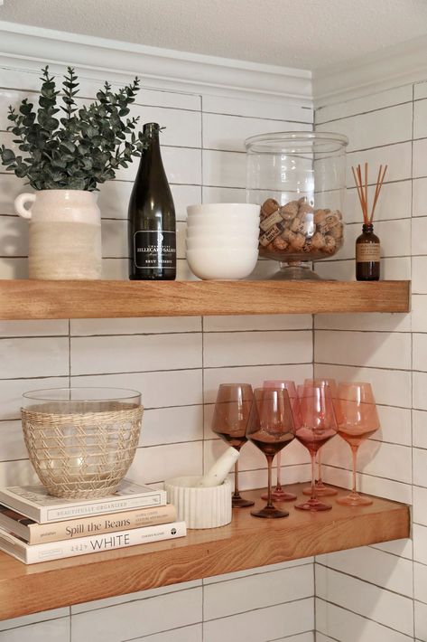 Open oak shelving in a white kitchen with colored wine glasses, stacked books, eucalyptus, and decor are shown! Wall Bathroom Shelves, Storage Over Toilet, Kitchen Floating Shelves Decor, Hanging Book Shelf, Open Shelving Decor, Small Kitchen Shelf, Kitchen Shelves Styling, Open Kitchen Shelving, Kitchen Open Shelving