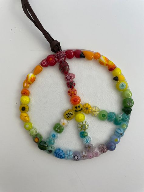 "Colorful fused glass peace sign Suncatcher. I love everything peace signs ! handmade multiple designs in murrini.  This one has a clear base and measures 3\" in diameter.  I love creating anything in peace signs. I can make these in several different colors of glass. I also do a rainbow colored one and dichroic glass one. Check my etsy store for more !  It hangs by a 4 inch deerskin leather lace cord." Peace Sign Clothes, Rainbow Peace Sign, Hippie Crafts, Rainbow Peace, Peace Necklace, Earthy Jewelry, Car Charms Mirror, Rope Crafts Diy, Peace Signs