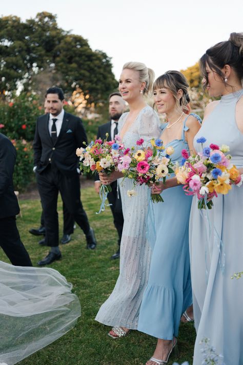 Kelsey & William's wedding at the Natural History Museum. Her bridesmaids were her "something blue" with their wildflower-inspired bouquets by Tularosa Flowers Blue And Wildflower Wedding, Colorful Lake Wedding, Blue Bridesmaids Colorful Flowers, Pink Yellow Blue Wedding Bridesmaid Dresses, Dusty Blue Wedding With Wildflowers, Ice Blue Bridal Party, Wildflower Wedding Bridesmaid Dresses, Bridesmaids With Colorful Bouquets, Wildflower Bridesmaids Bouquet