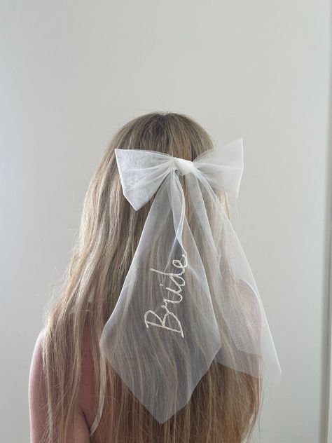 FREE DELIVERY WORLDWIDE! Look at this cute personalised veil wedding hair bow in ivory. Each Tulle Bow is hand made in my studio out of veil offcuts so they are ZERO WASTE! Which makes this the perfect bow bachelorette hair accessory for your wedding celebrations or After Party. The perfect gift either to yourself or your bride to be. Each Bridal Bow is stitched with your choice of custom word 'Bride' or 'Mrs' or 2x 'intertwined love hearts' with custom initials inside each heart & in the colour Personalised Veil, Bow Bachelorette, Wedding Hair Bow, Veil Bow, Bachelorette Hair, Bow Veil, Bachelorette Veil, Bridal Bow, Party Veil