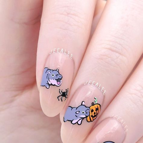 Stephanie - Nail Artist & Luxe Nail Polish Maker on Instagram: "Boo Deng!! She’s screaming at the spiders for me! 

Moo Deng is ready for Halloween! Biting on pumpkins is probably not as fun as biting on knees, though :3

..

Peach jelly nail polish is three coats of “Slip” from JL Lacquer

.
.
.

#freehandnailart #nailart #handpaintednailart hand painted Halloween Moo Deng baby hippo and ghost spooky season nail art design #moodeng" Axolotl Nail Designs, Cute Ghost Nail Art, Hippo Nails, Cute Animal Nail Art, Thailand Nails, Hand Painted Halloween, Peach Jelly, Jelly Nail Polish, Animal Nail Art