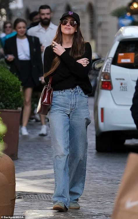 Dakota Johnson stuns in sweater and jeans with friends in Rome Dakota Johnson Outfits Casual, Dakota Johnson Fashion, Black Shirt And Jeans Outfit, Light Green Sneakers, Dakota Johnson Street Style, Daily Uniform, Brown Aviator Sunglasses, Sweater And Jeans, Dakota Mayi Johnson