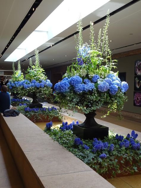 Dark Blue Floral Arrangement, Hotel Foyer Flowers, Lobby Flower Arrangement Hotel, Tall Blue Floral Centerpieces, Magnolia Christmas Decor, Blue Floral Installation, Luxury Flower Arrangement, Hotel Flower Arrangements, Floristry Design