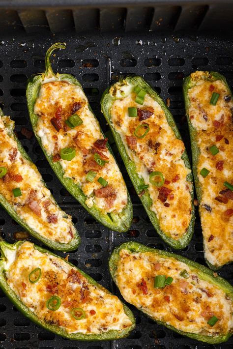 Cheesy air fryer jalapeno poppers up the game when it comes to party appetizers. These bite-sized spice bombs are stuffed with cream cheese, green onions, cheddar cheese, crumbled bacon, and an optional crispy breadcrumb topping! Jalopena Popper Recipe Air Fryer, Jalapeno Popper Bites Air Fryer, Crab Jalapeno Poppers, Halopinio Poppers, Air Fried Jalapeno Poppers, Jalopena Poppers, Healthy Jalapeno Poppers, Air Fried Jalapeno, Air Fryer Jalapeno Poppers