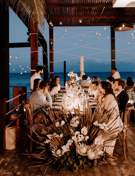 This Tulum wedding was the best of boho and modern minimalist wedding design. The bride wore a silk crepe gown and the decor featured bold, beachy style. For the ceremony, they constructed a large wooden frame to highlight the ocean view and for the reception, they had a dried palm flower wall, orchids and candles on the tables and rattan furniture. White bridesmaids dresses, beach Groom attire, and an intimate reception made this a dreamy destination wedding! #tulum #destinationwedding #gws #gr Minimalist Wedding Design, Tulum Mexico Wedding, Beach Groom, Destination Wedding Cost, Beach Views, Tulum Wedding, Beachy Style, White Bridesmaid Dresses, Modern Minimalist Wedding