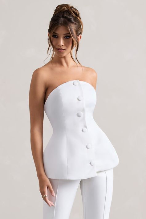 Whatever you decide to pair it with, Century is a stand-out staple. Arriving in a soft cream shade of our signature satin, this structured piece cinches your waist through self covered buttons that flow down its front.Features - Premium satin- Structured fit - Curved bandeau neckline- Self-covered buttons- Zip closure - Ruffled hemline - Corset designSizing & Fit Model is 5'7 and wears UK size 8 / US size 4Product Information Designed exclusively by Club L London Lined with no stretch Premium satin in Cream (100% Polyester) 53cm total length SKU: CL132309028 Clothing Line Branding, Corset Designs Ideas, Built Up Neckline, Corset Neckline, Corset Styling, Classy Vintage Outfits, Elegant Corset, Stylish Business Outfits, Cheap Cosplay