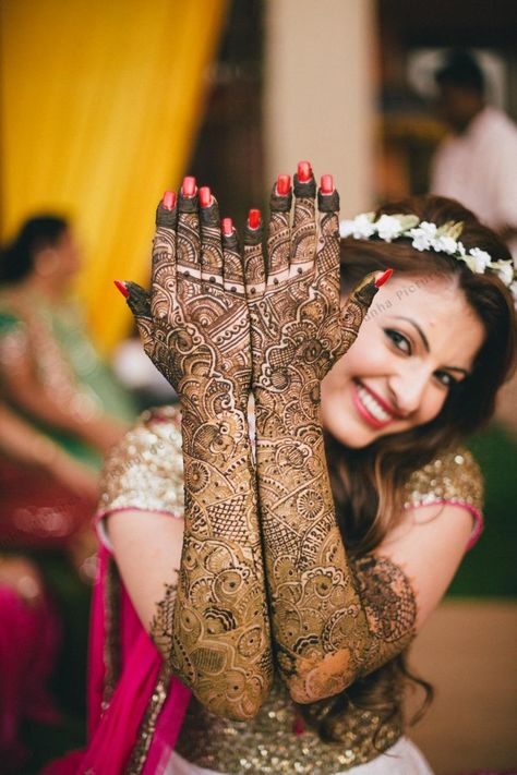 Photo of Bride showing off traditional bridal mehendi Mehendi Photography Bridal, Mehendi Photoshoot, Bridal Mehendi Designs Wedding, विवाह की फोटोग्राफी की मुद्राएं, Mehendi Photography, विवाह की दुल्हन, शादी की तस्वीरें, Indian Bride Poses, Indian Bride Photography Poses