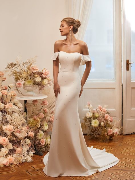 Have you ever seen anything like Moonlight Tango T963? This crepe mermaid wedding dress has shimmering pearls adorned from its soft sweetheart neckline to its sweep train both front and back. The uniquely chic T963 also features a detachable off the shoulder sleeve and will have your guests swooning at your luxury, beach, or minimalist wedding. #mermaidweddingdress #crepeweddingdress #pearlweddingdress Gown With Pearls, Moonlight Dress, Fairytale Bridal, Moonlight Bridal, Casual Beach Wedding, Modern Bridal Gowns, Pearl Wedding Dress, Crepe Wedding Dress, Bridal Details