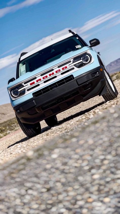 a blue and white 2023 ford bronco heritage sport edition driving in the direction of a low angle camera close to the ground. Ford Bronco Heritage, Bronco Sport Heritage, Bronco Heritage, New Ford Bronco, Ford Bronco For Sale, Bronco Sport, Bronco Sports, Ford Bronco, Retro Chic