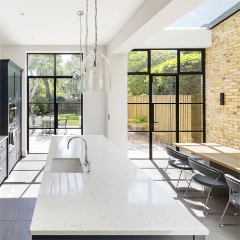 We love the entire aesthetic of this space. The bright light from the windows and skylight, contrasting with the brickwork wall inspired a striking, bold kitchen design. The Little Greene Basalt 221 colour on the shaker units comes into its own here, with the stunning Silestone Lyra quartz worktop finishing off the look perfectly. #interiordesign #interiorgoals #interiorinspo #interiorinspiration #kitchendesign #designerkitchen #bespokekitchens #bespokekitchen #kitchengoals #dreamkitchen #drea Kuhinje Ideas, Rear Kitchen Extension, Camberwell London, Crittall Windows, Dark Blue Kitchens, Crittal Windows, Bold Kitchen, Bedroom With Bath, Steel Windows