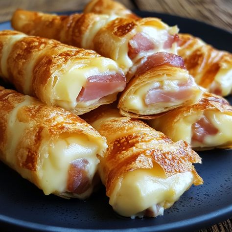 Ham and Cheese Sticks Ingredients : 🧀 200g of cheese (Gruyère, Emmental, etc.) 🥓 200g cooked ham 🥖 8 slices of sandwich bread 🥚 2 eggs 🥛 100ml of milk 🌿 A few sprigs of chives (optional) Ground black pepper Butter for cooking Instructions : 🧀 Cut the cheese into sticks about 1 cm wide and the same length as the slices of sandwich bread. 🥓 Also cut the ham into sticks similar in size to those of the cheese. 🥚 In a shallow bowl, beat the eggs with the milk. Season with ground black pepper to... Ham And Cheese Jambons, Cheese Twists, Cooked Ham, Cheese Stick, How To Cook Ham, Cheese Sticks, Shallow Bowl, Delicious Snacks Recipes, Retro Recipes