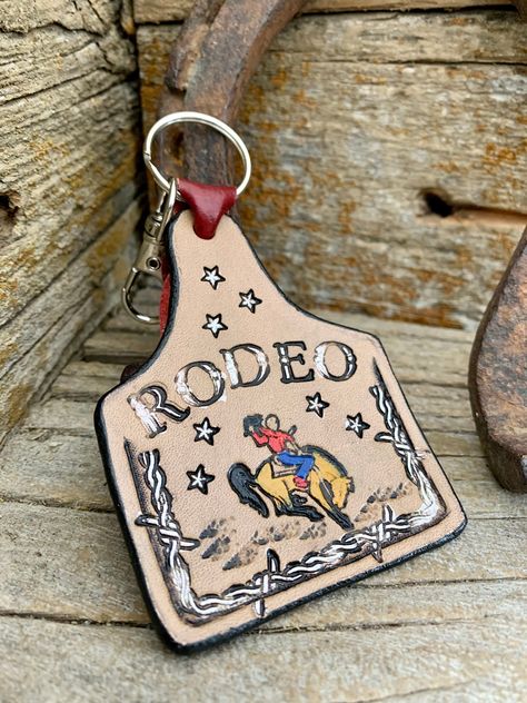 Cow tag shape with barbed wire featuring a bucking bronco and rider! Handmade Leather Work, Bucking Bronco, Head Ring, Travel Jewelry Box, Bouquet Wrap, Make An Effort, Thumb Rings, Travel Jewelry, Wrap Rings