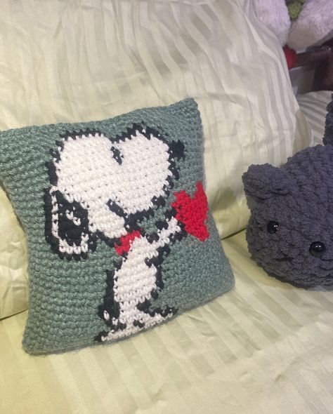 This has to be my favorite🤍 I love snoopy and I was so eager to make a tapestry of snoopy holding heart.I saw so many on Pinterest and finally I had the courage to make one. I wasn’t sure if I can successfully make this because it’s not SIMPLE CROCHETING and yes I made mistakes I even had to redo some rows😄 Well,to make a cushion was not my plan, I wanted to make a bag but when I was done with the tapestry I got to know that this won’t look good as a bag.., For a bag it should be a wider,s... Snoopy Tapestry Crochet, Snoopy Tapestry, I Made Mistakes, Crochet Snoopy, Snoopy Stuff, Make A Bag, Holding Heart, 2024 Christmas, Crochet Tapestry