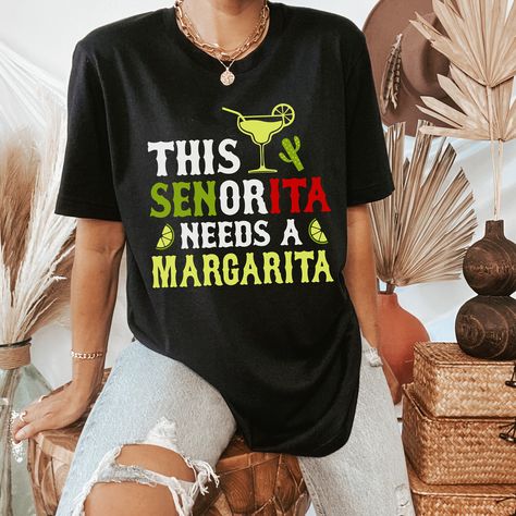 cinco de mayo shirt for women that says this senorita needs a margarita on a black shirt with a margarita glass, limes, and cactus for cinco de mayo party. the shirt is a thin lightweight material perfect for patio weather Drinking Shirts Women, Mexican Margarita, Cinco De Mayo Celebration, Party Outfits For Women, 5 De Mayo, Drinking Shirts, Taco Tuesday, Limes, Shirt For Women