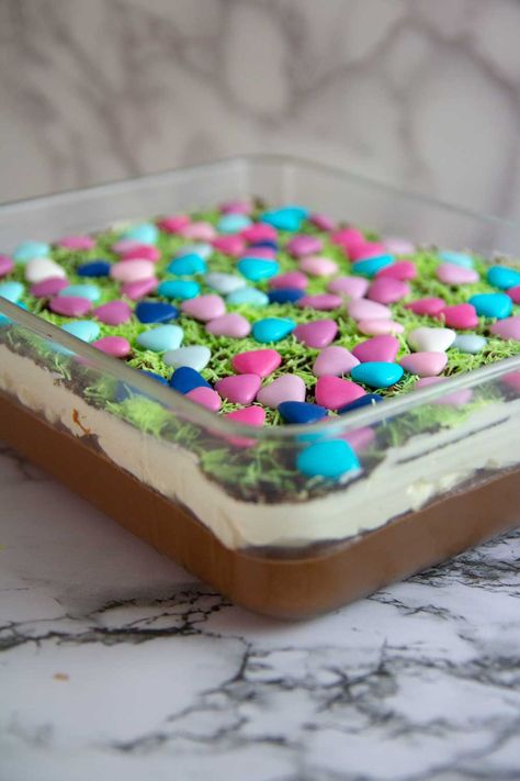 Easter Dirt Cake is a creamy and delicious dessert filled with Oreos, chocolate pudding, cheesecake that everyone will love to decorate and eat! #easterdessert Easter Dirt Cake Casserole, Chocolate Pudding Cheesecake, Easter Dirt Cake Recipe, Classic Easter Desserts, Dirt Cake Recipe, Easter Dirt Cake, Oreo Dirt Cake, Yummy Easter Desserts, Dirt Cake Recipes