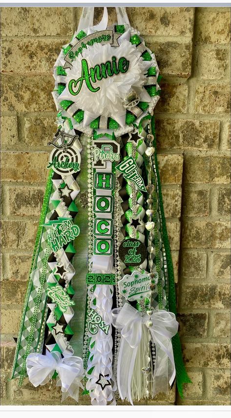 Mums Homecoming Medium, Homecoming Mum Head Ideas, Sophomore Mum, Hoco Mums Ideas Sophomore, Sage Green Mums Homecoming, Green And Gold Homecoming Mums, Green Black And White Homecoming Mum, Homecoming Mums Ideas Unique, Two Flower Homecoming Mum