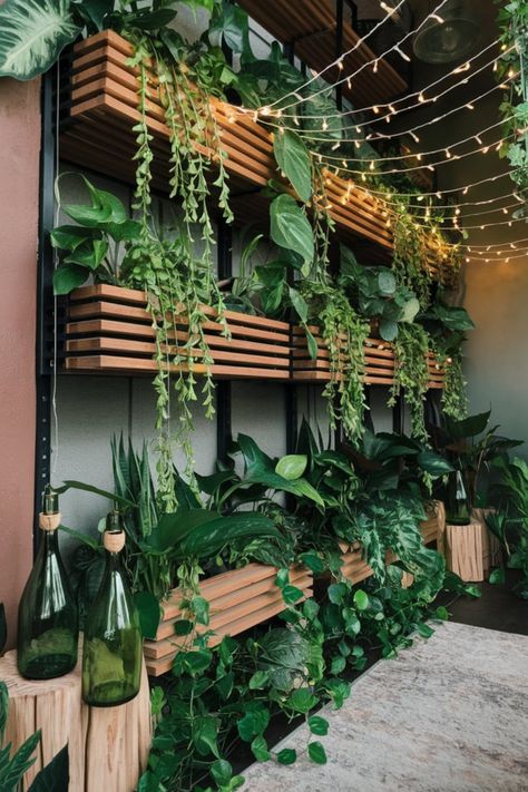 Transform your space into a magical jungle retreat with lush plant shelves overflowing with cascading vines and leafy greenery. Golden fairy lights add a soft glow, while green wine bottle lanterns mounted on wood provide a creative, rustic lighting accent. #FairyGlowJungle #ModernJungleDecor #IndoorGreenery #NatureInspiredDesign #EcoChicLighting #JungleVibes #CozyRetreat #RusticAccents #FairyLightMagic #TranquilAesthetic Jungle House Aesthetic, Jungle Retreat, Wine Bottle Lanterns, Golden Fairy, Led Bottle Light, Green Wine Bottle, Pub Garden, Aesthetic Bar, Magical Jungle