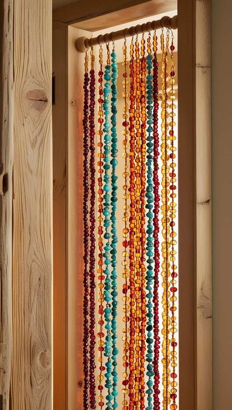 A vibrant beaded curtain hanging in a softly lit, boho-inspired doorway. Bead Door Curtain Diy, Hippie Crafts Diy, Boho Diy Crafts, Bead Door Curtain, Beaded Curtains Diy, Bead Door, Hanging Door Beads, Beaded Wall Hanging, Curtain Diy