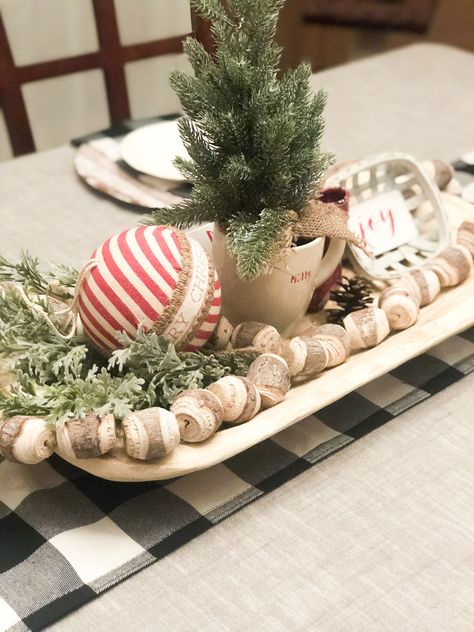 Christmas dough bowl.  Rustic centerpiece.  Farmhouse dough bowl. Rustic Christmas Dough Bowl, Wooden Dough Bowl Christmas Centerpiece, Dough Bowl Christmas Ideas, Christmas Doughbowl Centerpiece, Christmas Dining Table Centerpiece Farmhouse, Bread Bowl Decor Centerpieces Christmas, Christmas Bread Bowl Centerpiece, Decorating Dough Bowls For Christmas, Wooden Bowl Christmas Decor