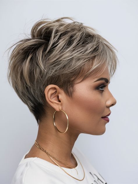 This short, textured pixie features a voluminous top and a clean cut along the sides, making it an excellent option for feminine pixie fans. Feminine Short Hair Pixie, Modern Pixie Haircut Over 50, Pixie Haircut Over 50, Textured Short Hair, Modern Pixie Haircut, Haircut Over 50, Short Asymmetrical Hairstyles, Feminine Pixie Cuts, Blonde Bob With Bangs