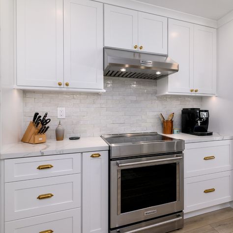 For this #tiletuesday we are showcasing the rich warmth of textured #zelligetile in contrast with a sleek induction range, this kitchen blends tactile beauty with modern minimalism. Tile: @zia_tile Appliances: @kitchenaidusa Cabinets: @fabuwood Hardware: @rejuvenation Countertop: @msisurfaces #zellige #backsplash #backsplashtile #kitchenbacksplash #kitchendesign #kitchen #kitchenremodel #kitchenrenovation #kitchenappliances #kitchenaid #inductioncooktop #kitchencabinets #whitekitchen ... Cabinets With Brass Hardware, Shaker White Kitchen, Zellige Backsplash, White Oak Floating Shelves, White Oak Flooring, White Shaker Kitchen Cabinets, Oak Floating Shelves, White Shaker Kitchen, Floating Shelves Kitchen