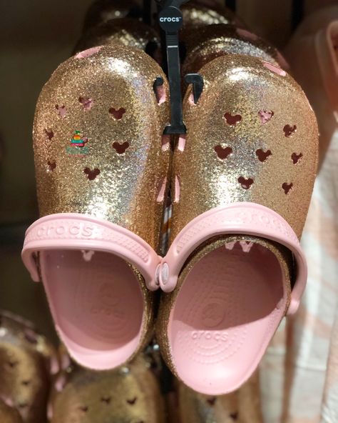 Rose Gold GLITTER CROCS!!! We found these at Disneyland!!! Do you ROCK THE CROCS?   Or won’t be caught dead in them????? Gold Crocs Shoes, Pink Bling Crocs, Glitter Crocs, Crocs Ballerina Pink, Pink Glitter Crocs, Pink Blinged Out Crocs, Disney Shopping, Crocs Ideas, Disney Shop