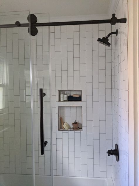 Vertical brick-set white subway tile gives this shower a modern vibe that different! Vertical Subway Tile Shower Wall, White Subway Tile Shower Ideas 3x6, Subway Tile Laid Vertically, 3x6 Vertical Subway Tile Bathroom, Vertical Tiles Shower Wall, Verticle White Subway Tile Bathroom, Staggered Vertical Subway Tile, Vertical White Subway Tile, Vertical Subway Tile Shower Ideas