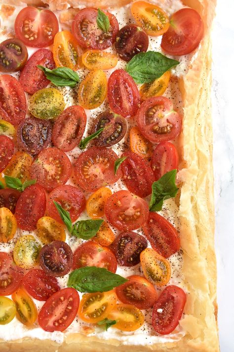 Tomato Basil Feta Tart features a flaky puff pastry tart with a whipped feta spread, the most flavorful tomatoes and fresh basil leaves for a tasty appetizer or side dish! www.nutritionistreviews.com #tomato #tomatoes #feta #basil #tart #appetizer #sidedish #vegetarian Cherry Tomato Pie, Tart Appetizer, Feta Spread, Feta Tart, Tomato Mozzarella Basil, Greek Appetizers, Puff Pastry Crust, Pastry Appetizer, Puff Pastry Tart