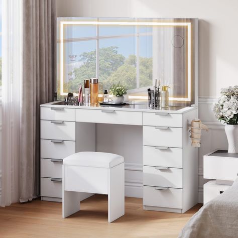 PRICES MAY VARY. Makeup Vanity Set with XL Illuminated Mirror: Sized at 46'' x 24.4'', this mirror offers a wide viewing angle for a comprehensive beauty perspective; The LED strip features 3 color modes for personalized lighting; adjust with a touch Cosmetics Storage Solution: With 11 drawers, this vanity provides ample space for makeup, fragrances, hair tools, and essentials; Stay organized and access your items easily Versatile Makeup Desk: Equipped with 2 plug sockets, 2 USB ports, and a hai Make Up Tisch, Glass Top Vanity, Makeup Vanity Storage, Lit Mirror, Storage Bench Bedroom, Mirrored Vanity Desk, Vanity Benches, Vanity Drawers, Desktop Design