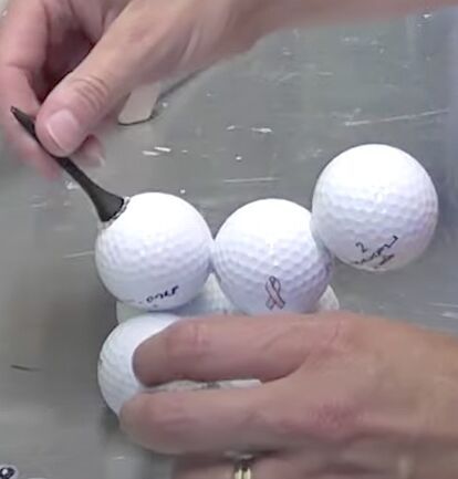 Now this is an EASY craft that you can whip out in no time! It is a golf ball dog!It’s a great idea for kids to make a Father’s Day gift!Materials You Will Need 7 golf balls Hot glue Black felt Black paint 1 Golf tee Ribbon (optional) Small white pom pom Small black bead Two googly eyes ﻿Here is the Video Tutorial DirectionsStep 1Start by gluing four golf balls together.Keep in mind that you need to put a dab of glue wherever the balls touch – it’s surprisingly stu… Golf Crafts, Golf Ball Crafts, Ball Wreath, Golf Tee, Ball Lamps, Dog Crafts, Googly Eyes, Golf Tees, Easy Craft