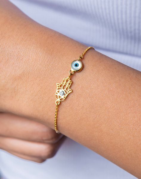 Evil eye, diamonds and beautifully done filigree gold work come together in this beautiful bracelet ! Set in 14 Karat solid  gold with a single piece diamond, this delicate filigree hamsa hand bracelet is the perfect finishing touch of protection in your everyday wardrobe! Specifications: Made in 14 kt solid gold Approx. Gold Weight- 2.2gmsTotal  Diamond weight: VVS Lab Grown Ethical diamonds approx 0.02 ct Featuring an evil eye made of mother of pearl, turquoise and black onyx Adjustable clasp with 3 extra links   Estimated delivery timeline: 10-15 days All our UB JEWELS jewelry comes with a velvet pouch for storage, premium gift box and bag. Evil Eye Hand, Evil Eye Hamsa, Sparkly Accessories, Angel Bracelet, Evil Eye Design, Hamsa Bracelet, Vvs Diamond, Family Necklace, Jewelry Bracelets Gold