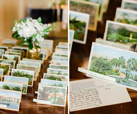 Old Florida Inspired Wedding Reception Escort Card Table with Vintage Postcards and Small White Floral with Greenery in Gold Vase | Tampa Bay Wedding Planner Glitz Events Vintage Postcards Wedding Decor, Postcard Wedding Favors, Vintage Postcard Seating Chart, Postcard Place Cards Wedding, Old Florida Wedding Invitations, Card Station Wedding, Post Card Wedding Seating Chart, Vintage Postcard Wedding Invitations, Florida Wedding Invitations