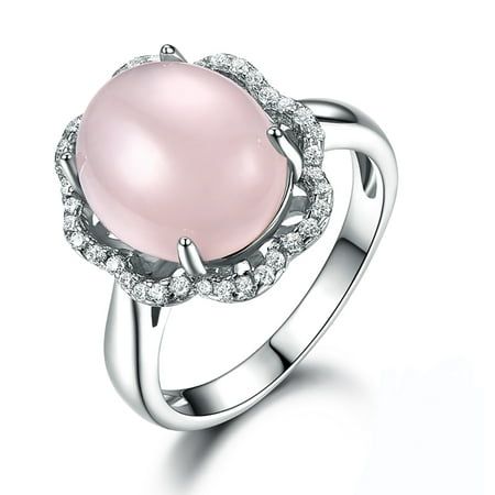 The Oval Rose Quartz Statement Ring from the Ginger Lyne Collection is a marvelous blend of natural beauty and refined elegance. This striking ring features a 10mm natural rose quartz, known for its gentle pink hue that symbolizes love and harmony. The soft, soothing tones of the rose quartz are beautifully complemented by the sparkle of clear AAA quality cubic zirconia accents, creating a stunning visual contrast. Crafted from .925 sterling silver, the ring's composition includes 92.5% fine sil Pink Gemstone Ring, Quartz Rings, Pink Gemstones Ring, Cheap Rings, Wedding Party Jewelry, Rose Quartz Ring, Band Jewelry, Pink Gemstones, Sterling Silver Flowers