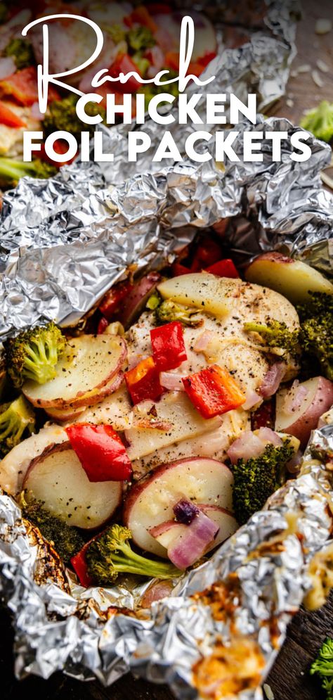 A close up view of a ranch chicken foil packet. Healthy Foil Packet Meals Ovens, Hobo Chicken Foil Packs, Foil Chicken Packets Oven, Foil Packets For The Oven Chicken, Chicken And Potato Foil Packets Ovens, Foil Dinners In Oven, Chicken Foil Packets For The Grill, Chicken Foil Packets For The Oven, Foil Packets For The Oven