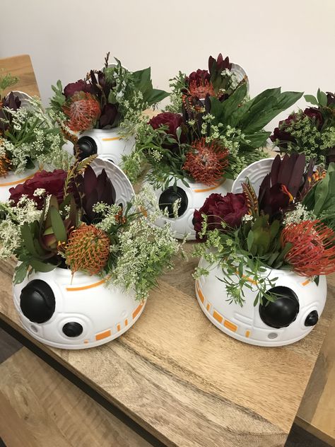 BB-8 Centerpiece Starwars Centerpiece Ideas Star Wars Wedding, Star Wars Birthday Party Centerpiece, Star Wars Bouquet Wedding Ideas, Mandalorian Centerpiece Ideas, Star Wars Flowers Arrangements, Nerdy Bridal Shower Ideas, Star Wars Quinceanera Theme, Star Wars Center Piece, Grogu Centerpiece