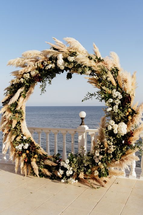 14 beautiful wedding ceremony backdrops for rustic weddings. Pampas grass Wedding Ceremony Ideas,rustic wedding ceremony backdrop ideas,circle wedding ceremony arch, round wedding ceremony arch with pampas grass and greenery, round wedding ceremony backdrop, outside wedding ceremony arch, unique wedding ceremony inspirations, rustic wedding ceremony arch flowers,wedding ceremony outdoor decoration, wedding arch decorations, round wedding arch flowers. www.ouritalianfairytale.love