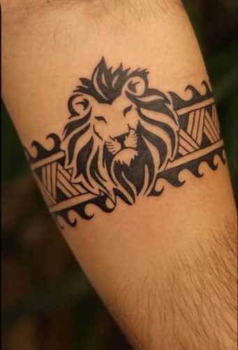 19 Express Strength with a Lion Tattoo on Forearm: Design Inspiration Unique Arm Band Tattoo Design For Men, Lion Trible Tattoos, Lion Symbol Tattoo, Lion Arm Band Tattoo, Best Tattoo Design For Men Unique, Lion Wrist Tattoo, Lion Band Tattoo Design, Bracelet Tattoo Men, Leo Tattoo For Men