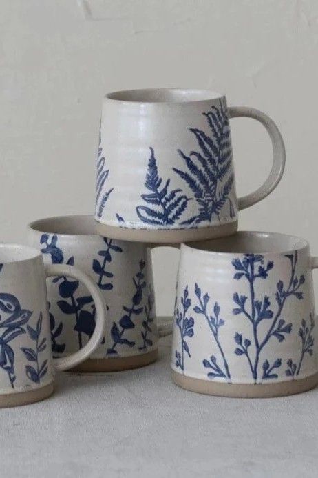 These stoneware mugs, featuring a hand stamped blue botanical pattern on a neutral background, are perfect for adding simple farmhouse charm to your morning coffee. 100% stoneware Sold individually- style will vary Measures 3.75"H x 4" Diameter (16oz) Each one will vary slightly in pattern and finish Cottage Mug, Mug Design Ideas, Vintage Inspired Home, Farmhouse Tabletop, Simple Farmhouse, Vintage Farmhouse Style, Make Do And Mend, Neutral Background, Reclaimed Wood Furniture