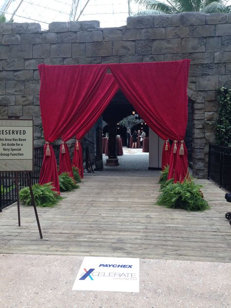 Red Drape Tunnel Entrance with ferns and up-light at each base #FLeventdecor African Masquerade, Venetian Masquerade Party, Event Entrance Arch, Stage Effects, Hollywood Prom, Js Prom, Tunnel Entrance, Red Carpet Entrance, Gala Decorations