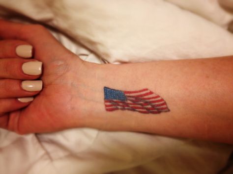 American flag wrist tattoo American Tattoo Patriotic Women, America Tattoo For Women, American Flag Tattoos For Women, Usa Flag Tattoo, Vacation Tattoos, American Flag Sleeve Tattoo, Canadian Tattoo, Flag Tattoos, Small American Flags