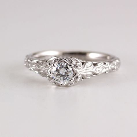 Vintage style engagement ring with Moissanite Vintage style wedding ring set, scroll and leaf pattern design in this detailed filigree setting. shown in a size 7 1/2, 14k white gold. The 14k white gold is shown with rhodium finish. Moissanite Forever One Charles and Colvard, created Moissanite Engagement ring has a 4.5mm RD Antique Style Engagement Rings Silver, Vintage Engagement Rings Unique 1930s, Round Cut Silver Engagement Ring, Vintage Engagement Rings Unique 1920s Silver, Vintage Wedding Rings Antique Silver, Vintage Filigree Engagement Ring, Vintage White Gold Engagement Rings, 1930s Engagement Ring, Gemstone Engagement Rings Silver