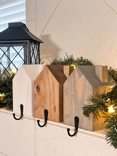 Rustic Holiday Charm in Every Home! Add a cozy, farmhouse touch to your Christmas mantle with these adorable Rustic House Stocking Holders! Each piece is lovingly handcrafted from solid wood, designed to look like a charming little house, perfect for hanging your stockings this holiday season. Whether you're going for a minimal, rustic, or farmhouse-inspired look, these stocking holders add a unique twist to your holiday decor. Handcrafted with Love: We build each house stocking holder by hand. Wooden Christmas Decorations For Outside, Wood Projects For Holidays, Diy Wood Holiday Projects, Wooden Home Projects, Barnwood Christmas Decor, Rustic Wood Projects To Sell, Simple Wooden Crafts To Sell, Fall Wood Decorations, Rustic Christmas Signs Wood