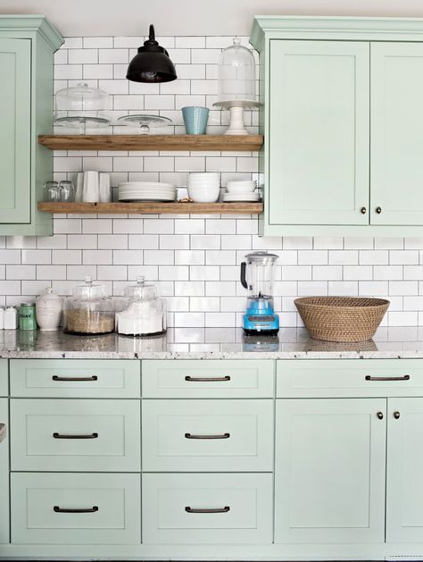 A fresh coat of paint is an easy and inexpensive way to update your kitchen cabinets. Whether you prefer a crisp neutral look or bold, standout shades, these crowd-favorite kitchen cabinet colors are sure to inspire. Use these popular cabinet paint colors as a guide for your own kitchen refresh. #kitchencolorschemes #kitchenideas #paintcolors #paintedcabinets #bhg Painting Laminate Cabinets, Mint Green Kitchen, Kitchen Cabinets Color Combination, Shelving Kitchen, Laminate Cabinets, Cabinet Paint, Green Kitchen Cabinets, Kitchen Refresh, Green Cabinets