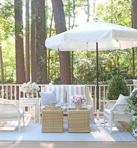 T U F T & T R I M on Instagram: “This is one of our favorite places to hang out this summer (when the weather allows)! Isn’t this fringed umbrella just the cutest?! 🤍 Shop…” Coastal Contemporary Living Room, Brick Exterior Makeover, Dining Area Rug, Contemporary Living Room Design, Gray And White Kitchen, Coastal Contemporary, Headboard Decor, Wicker Dining Chairs, Blue Cottage