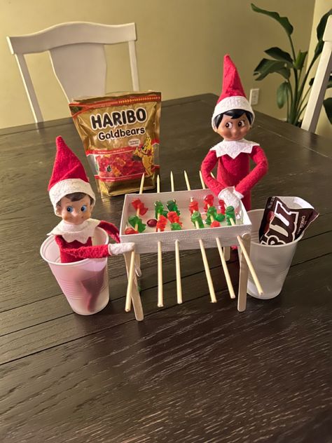 Elf On The Shelf Apples, Elf On The Shelf Playing Foosball, Elf Foosball, Elf On The Shelf Ideas Gummy Bears, Elf On The Shelf With Treats, Elf Treats For Kids, Elf Football Ideas, Elf On The Shelf Ideas With Candy, Football Elf On The Shelf